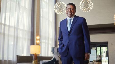 Robert L Johnson stands in a hotel lobby