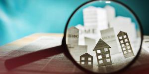 Photo illustration of magnifying glass examining housing listings.